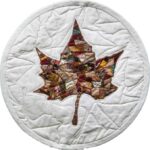 round white quilt with autumn sycamore centrally